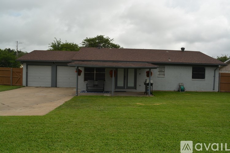 A house with a brown roof and a grey garage door.