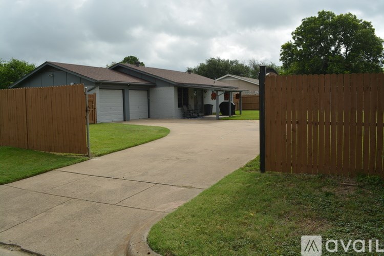 A house with a brown fence in front of it.