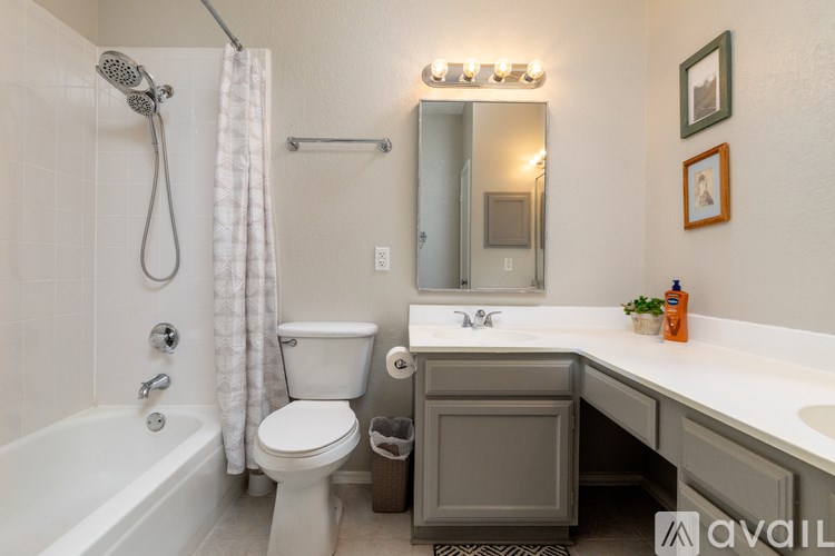 A bathroom with a white tub, toilet, and sink.