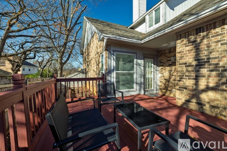 A balcony with a table and chairs is shown.