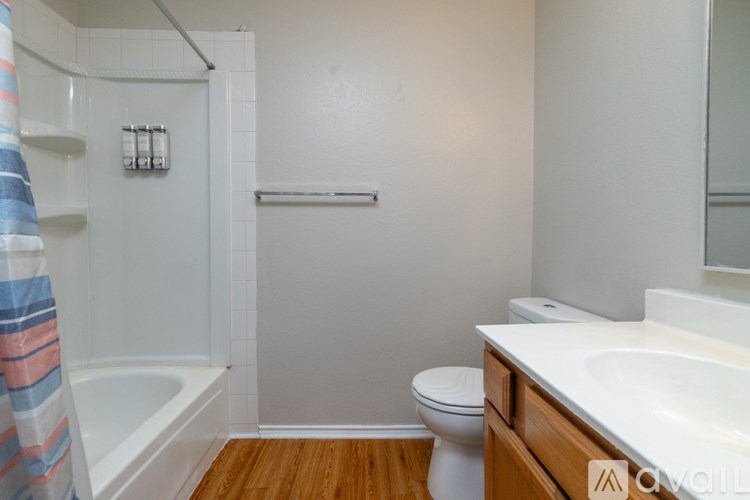 A bathroom with a toilet, sink, and bathtub.