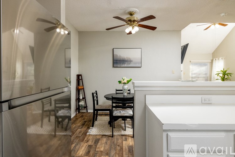 A modern kitchen with a dining table and chairs.