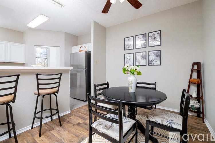 A kitchen with a table and chairs.