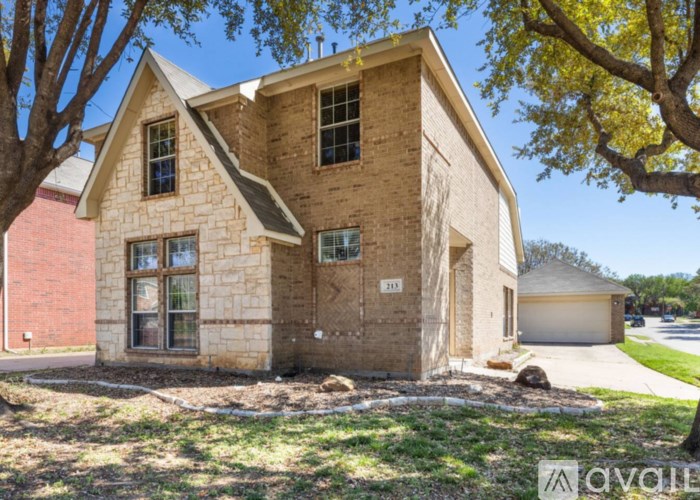 A house with a brown facade is for sale.