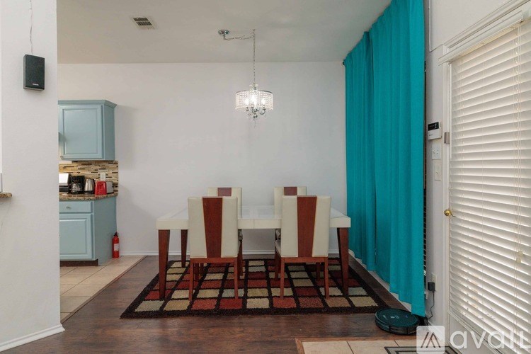 A dining room with a table set for four.