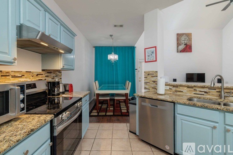 A kitchen with blue cabinets and granite countertops.