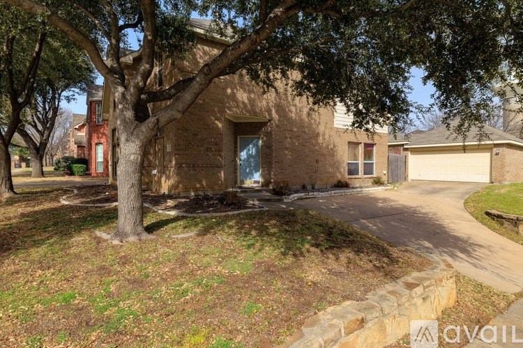 A house with a tree in front of it.