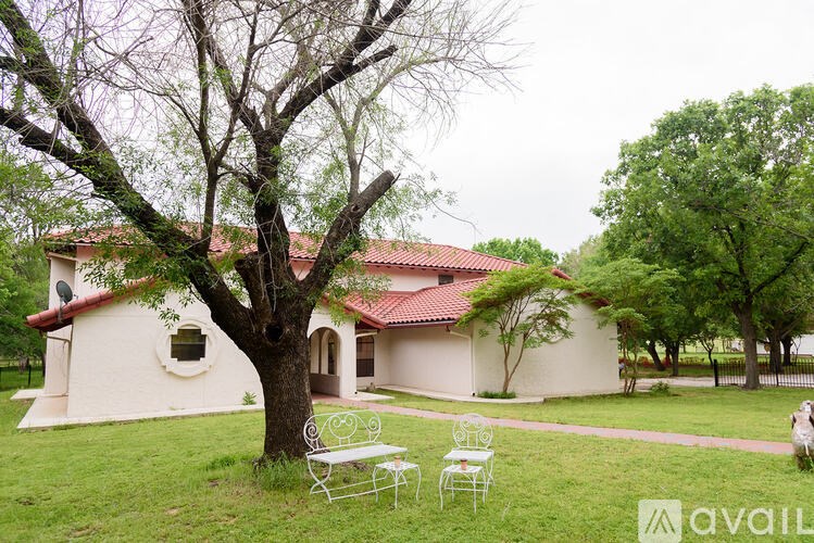 A house with a red roof and a tree in front of it.