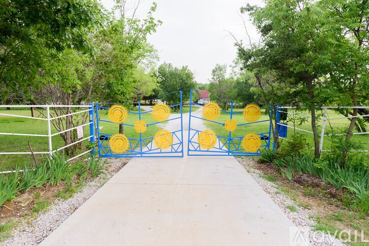 A blue gate with yellow circles on it.