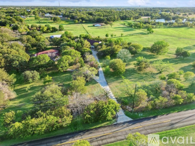 A rural landscape with a road and a river.