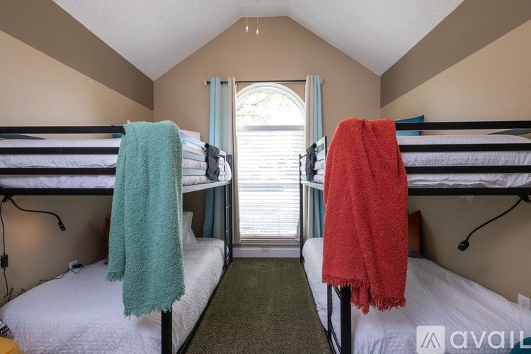 A room with two bunk beds and towels hanging on the side rails.