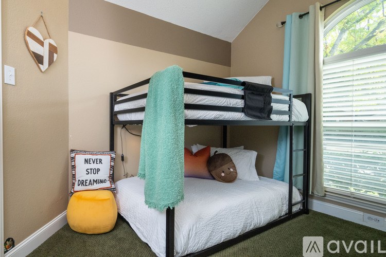 A bedroom with a bunk bed and a sign that says "Never stop dreaming".