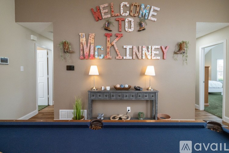 A pool table with a sign that says "Welcome to McKinney" above it.