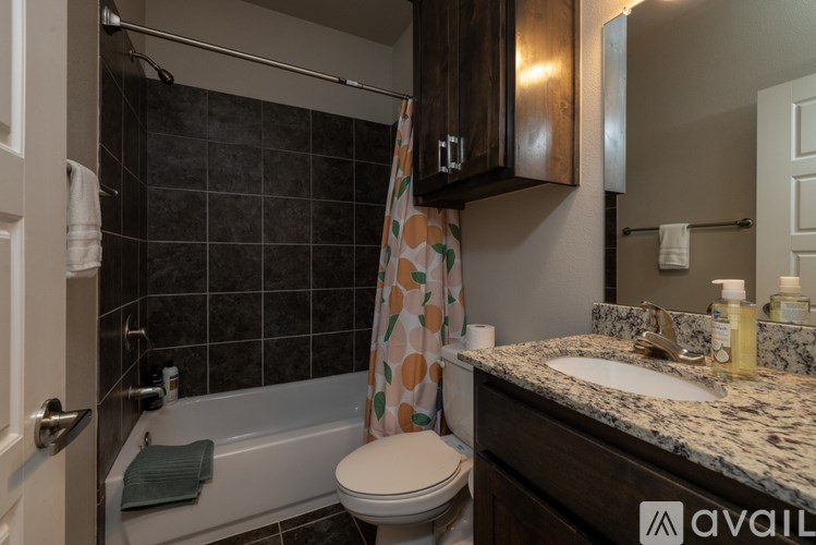 A bathroom with a toilet, sink, and shower.