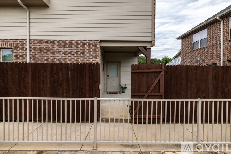 A house with a white fence in front of it.