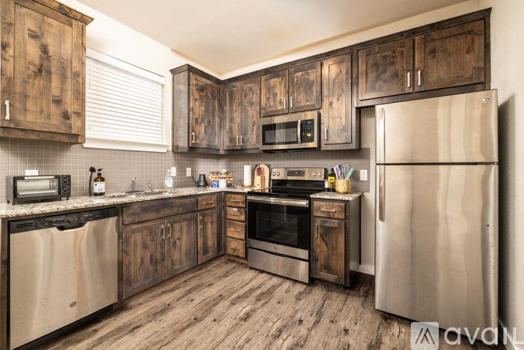A kitchen with wooden cabinets and stainless steel appliances.
