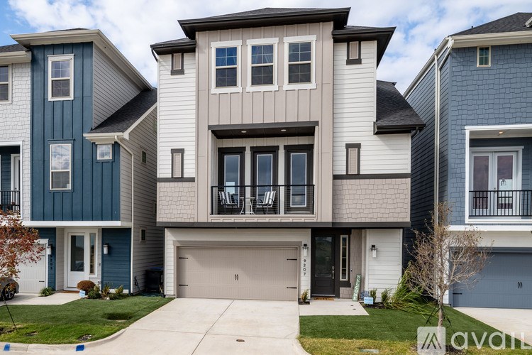 A row of houses with a garage door in the foreground.
