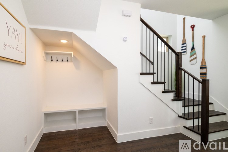 A staircase with a black railing and wooden steps.