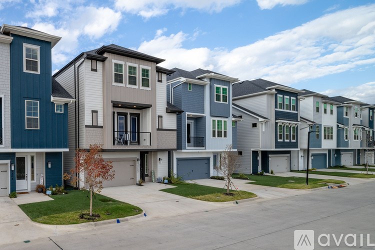 A row of modern houses with a clear sky above them.