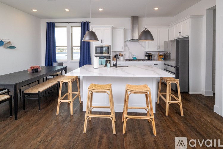 A kitchen with wooden floors and a black countertop.