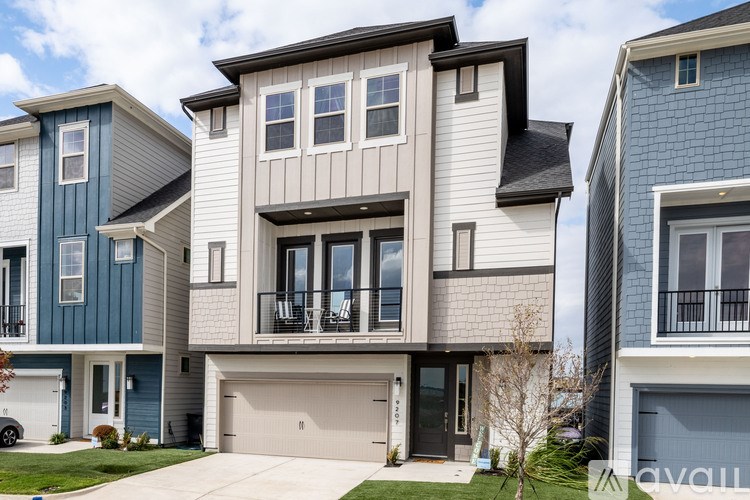 A row of houses with the middle one having a balcony.