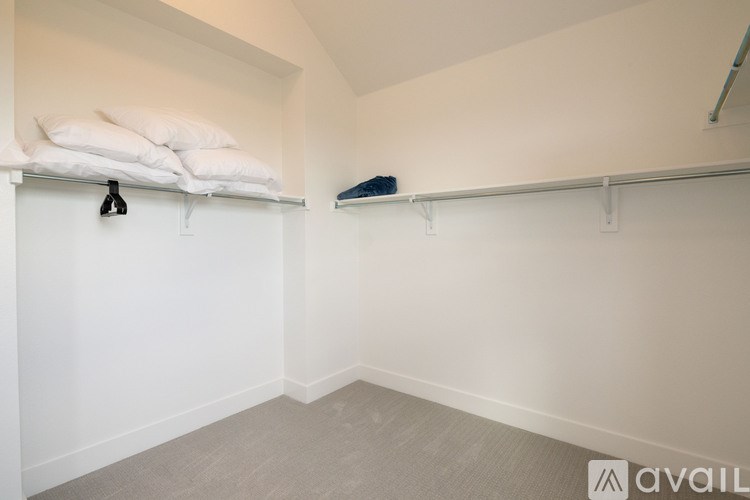 A room with a bed and a bench.