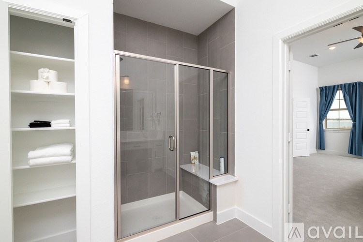 A bathroom with a walk-in shower and a towel rack.