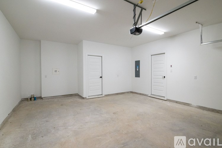 A room with white walls and a concrete floor is available for rent.