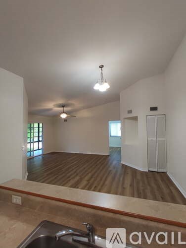 A kitchen with a sink and a ceiling fan.