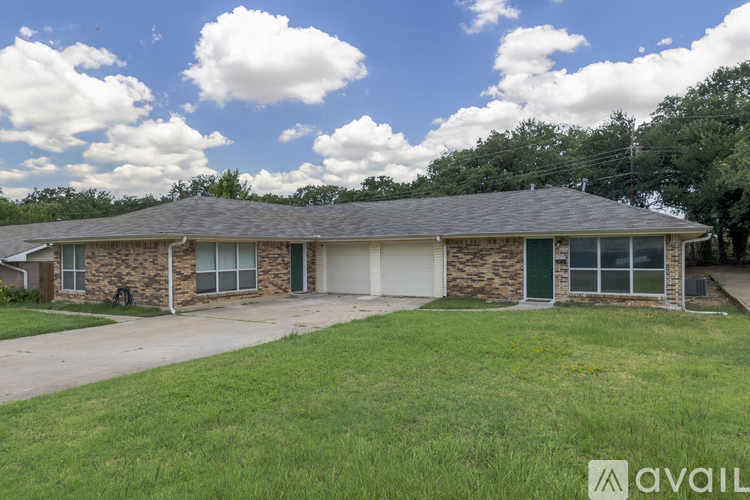 A house with a green garage door is for sale.
