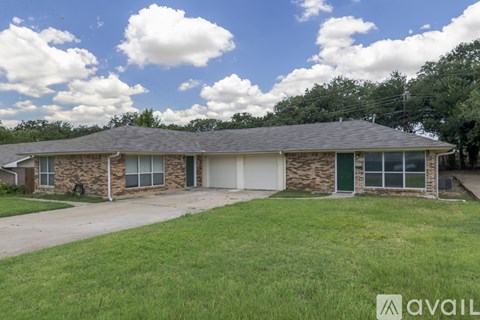 A house with a green garage door is for sale.