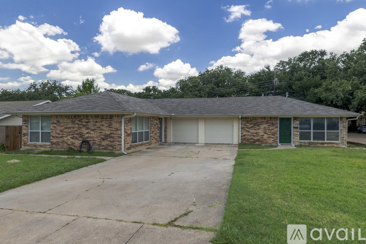 A house with a stone facade and a grey roof is for sale.