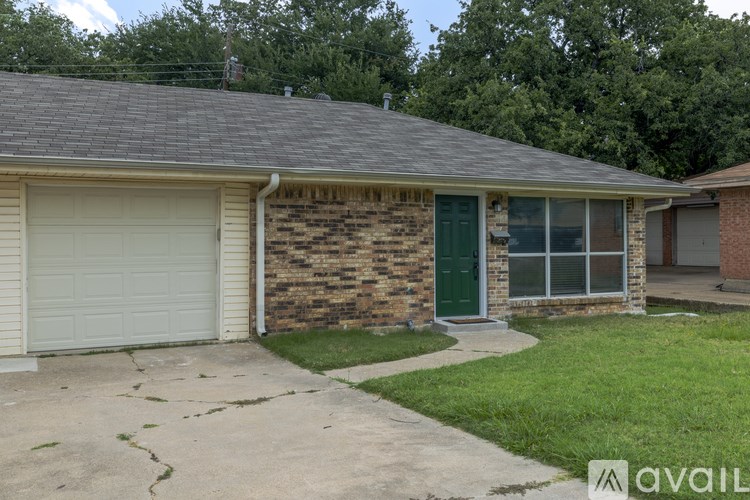 A house with a green door and a white garage door.