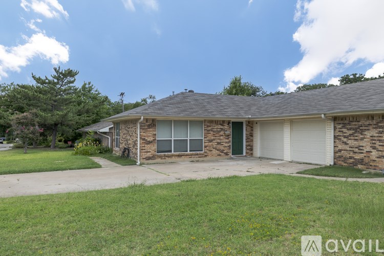 A house with a stone facade and a green door is for sale.