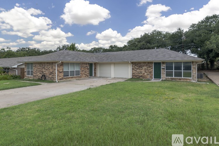 A house with a stone facade and a grey roof is available for sale.