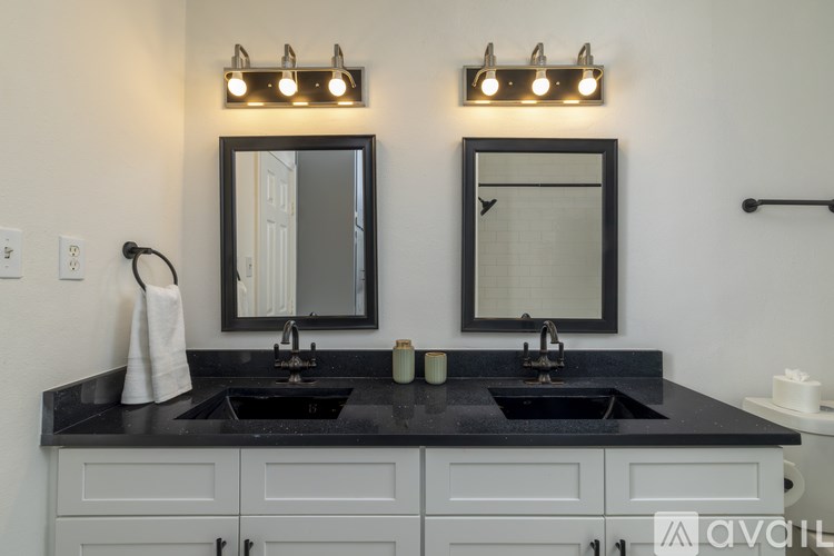 A bathroom with two sinks and two mirrors.