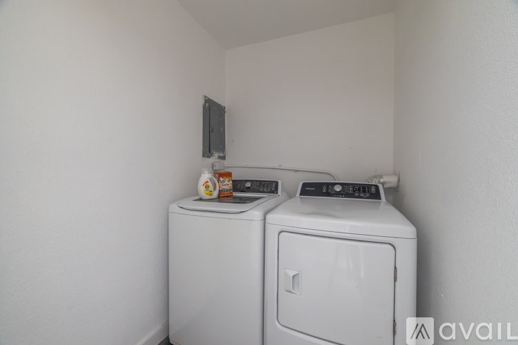 A small laundry room with a washer and dryer.