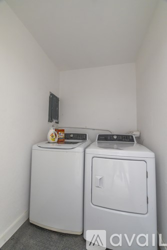 A small laundry room with a washer and dryer.