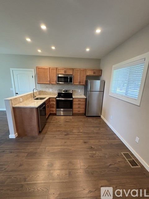 A kitchen with wooden cabinets and a refrigerator.