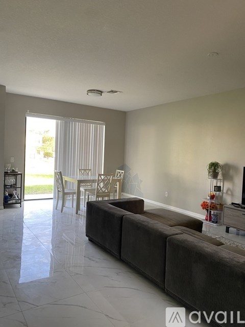 A living room with a grey couch and a television.