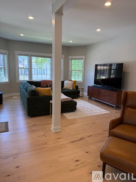 A living room with a television and a couch.