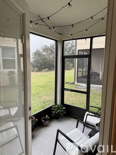 A patio with a table and chairs is visible through a glass door.