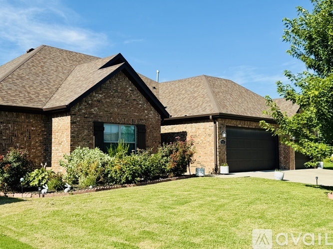 A house with a brown roof and a garage door.