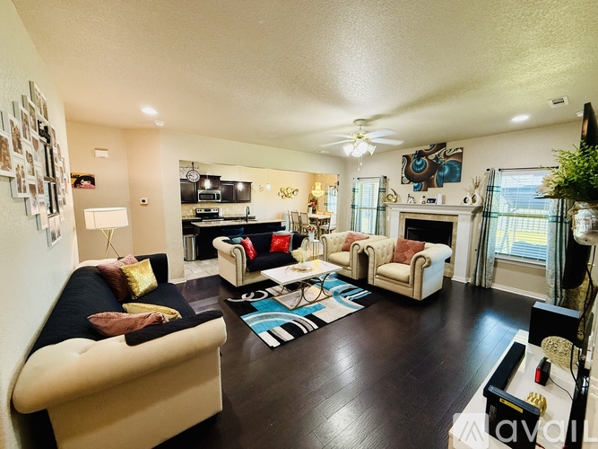 A living room with a white couch and a black and white rug.