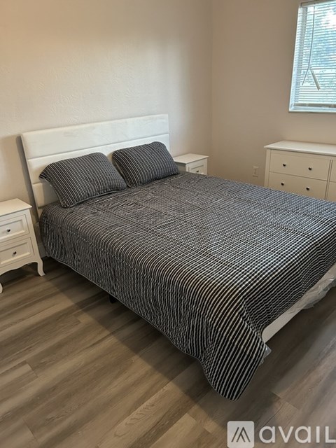 A room with a ceiling fan and tile flooring.
