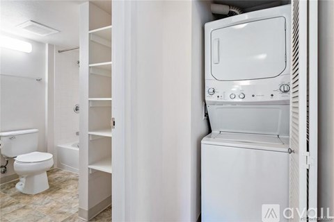 A white oven is built into a wall in a kitchen.