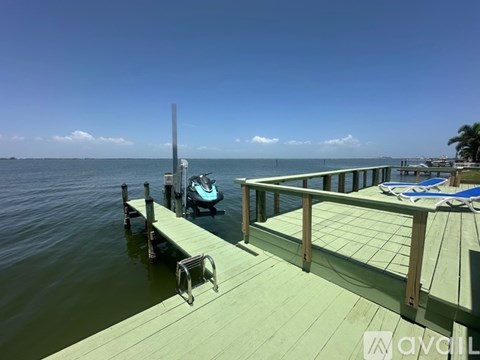 A dock with a boat and a chair on it.