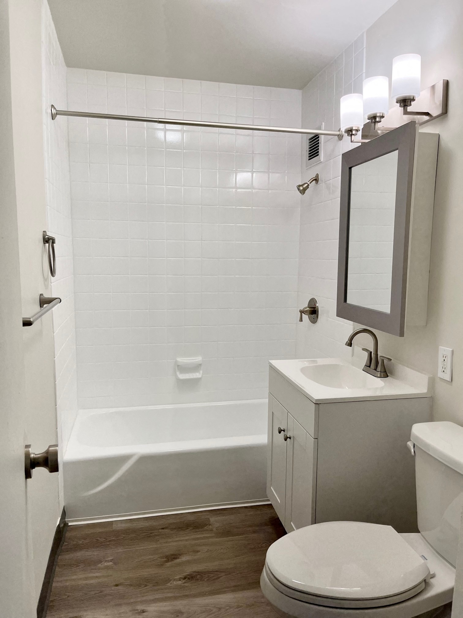 a small bathroom with a shower and a sink and a toilet