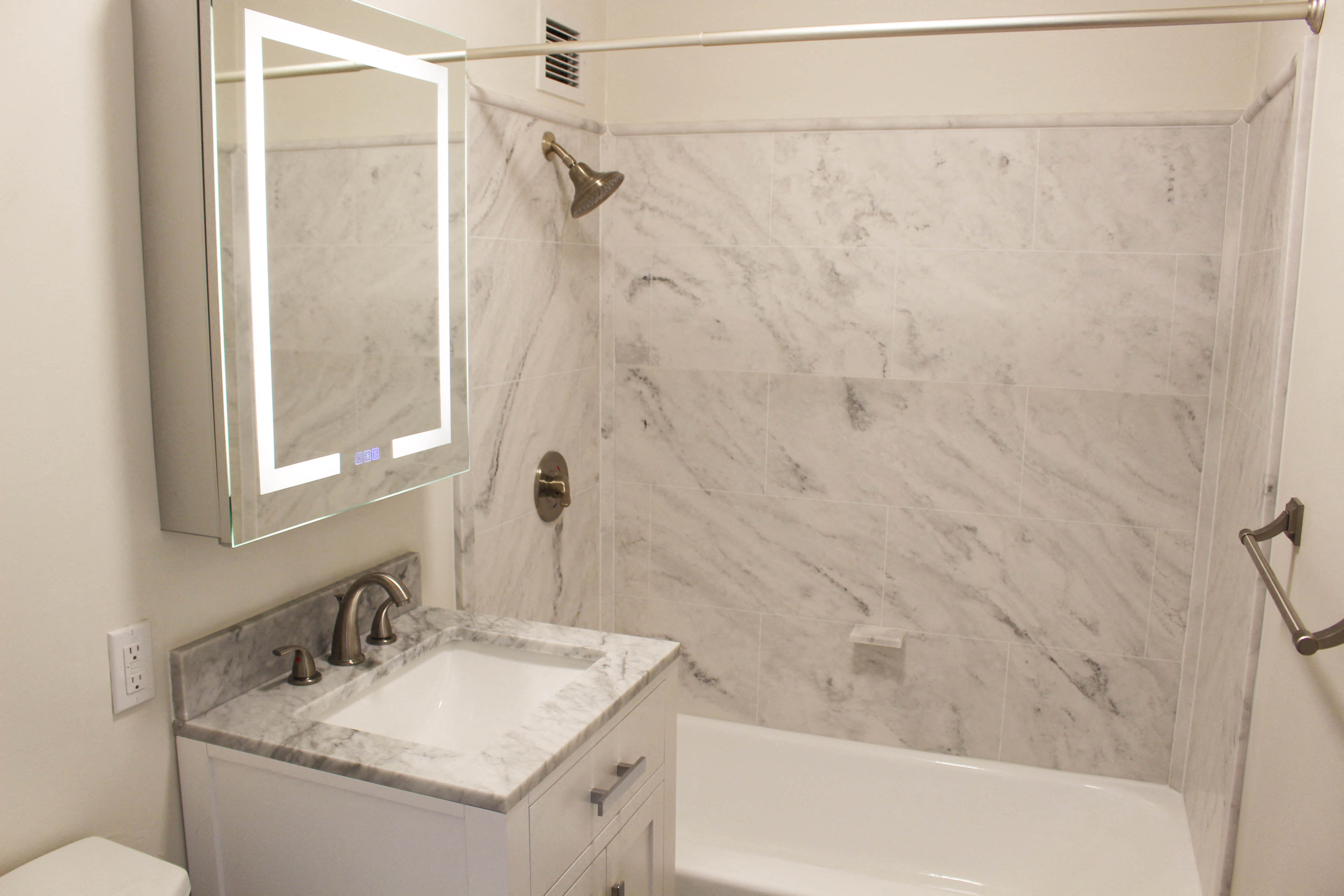 a small bathroom with a sink and a shower