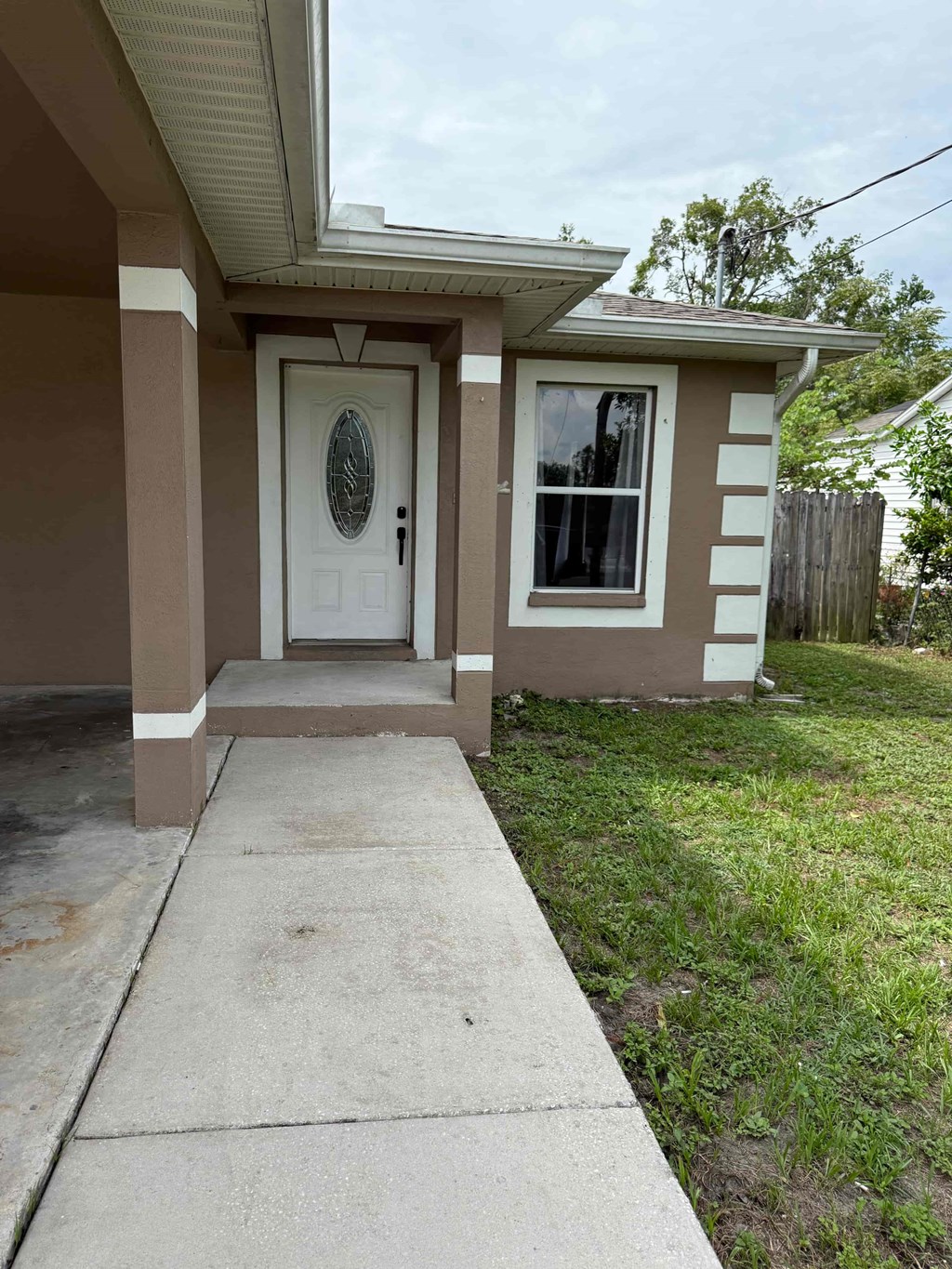 A small house with a white door and a window.